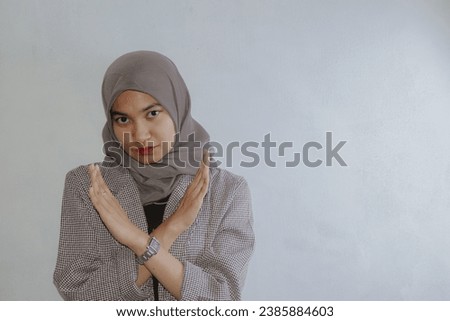 Asian women with isolated white background are giving cross -hand cross. He looks serious