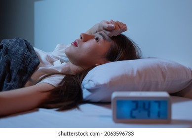 Asian Women Opened Eyes Lying On The Bed Have An Insomnia Problems.