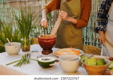 Asian women preparing fresh fruit and vegetable salad with lime juice - Thai tradiotional food concept