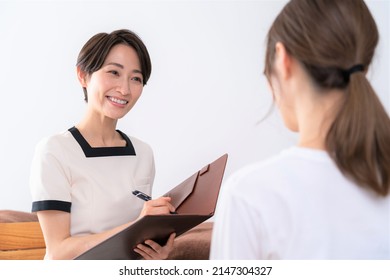 Asian Women Receiving Courteous Counseling