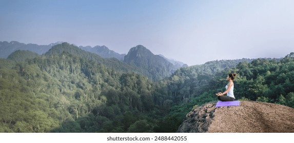 Asian women relax in the holiday. Play if yoga. On the Moutain rock cliff. Nature of mountain forests in Thailand. Young woman practicing yoga in the nature female happiness. exercise yoga - Powered by Shutterstock