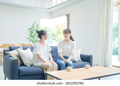 Asian women talking at the living room - Powered by Shutterstock