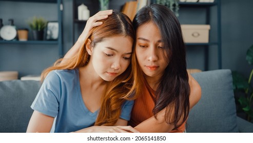 Asian Women Teenager Embracing To Calm Her Sad Best Friends From Feeling Down From Breakup With Boyfriend In Living Room At Home. Friendship Counseling And Care, Unhappy Girl Support Her Girlfriend.