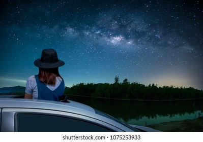 
Asian Women Tourist Standing In A Sunroof Car Watching The Sky And The Milky Way At Night