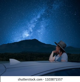 Asian Women Tourist Standing In A Sunroof Car Watching The Sky And The Milky Way At Night