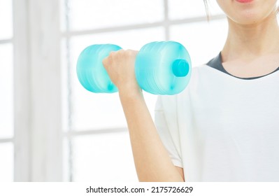 Asian Women Training Their Muscles With A Dumbbells, No Face