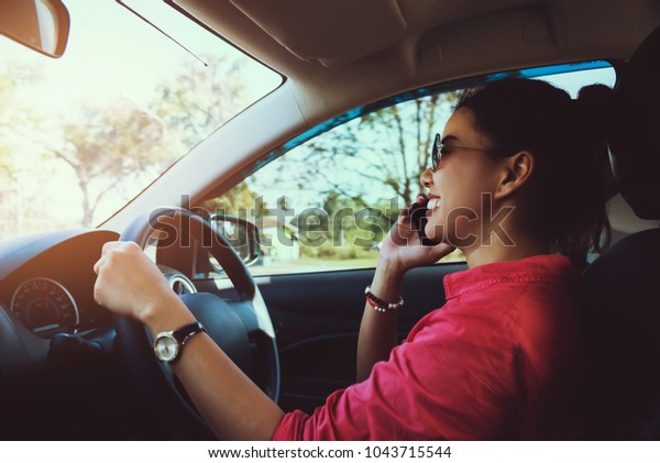 Asian women travel relax\
in the holiday. drive a car\
Happy travel. talking on the phone.\
Thailand