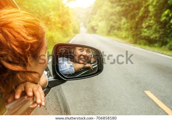 Asian women travel relax in the holiday. driving\
a car traveling happily.