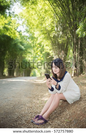 Asian women using cell phones.
