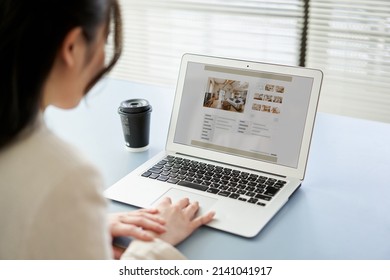 Asian women viewing real estate websites on a computer - Shutterstock ID 2141041917