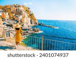 Asian women visiting Manarola in Cinque Terre Italy, Manarola Village Cinque Terre Coast Italy. Manarola is a beautiful colorful town of La Spezia Liguria and one of the five Cinque Terre