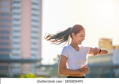 Asian Women Is Watching The Sport Watch Or Smart Watch For Jogging On City