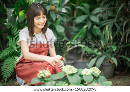 Asian women watering flower in garden