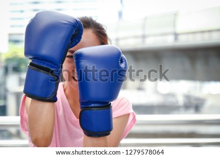 
Asian women wear blue boxing gloves, exercise for good health, and protect themselves. Sports concepts