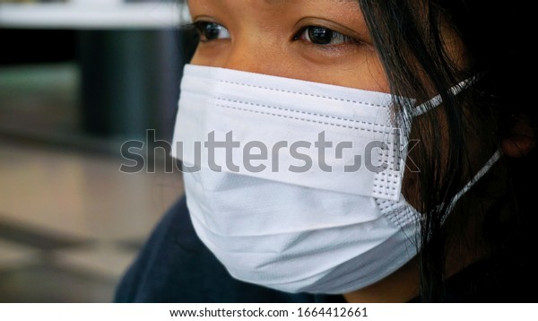 The Asian women wear a mask in daily life to\
prevent the spread of\
germs.