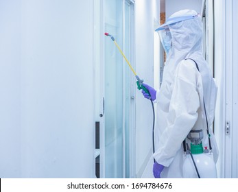 Asian women wear personal protective suits or PPE, goggles, masks, and gloves making disinfection and decontamination on public place to reduce spreading of disease. Covid-19, coronavirus concept - Shutterstock ID 1694784676