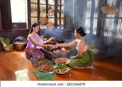 Asian Women Wearing Thai Traditional Dresses Cooking Thai Traditional Food In The Thai Ancient House Ayutthaya,Thailand