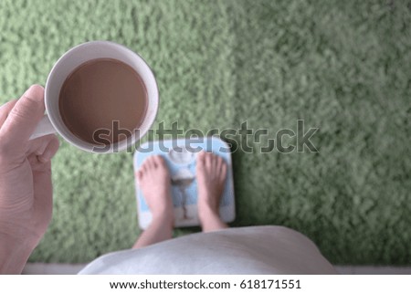 Asian women Weighing And hold the coffee in hand. Concept with Weight loss