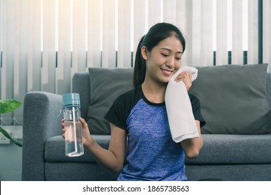 Asian Women Wiping Their Sweat Away After Exercising At Home.