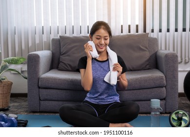 Asian Women Wiping Their Sweat Away After Exercising At Home.