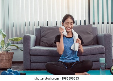 Asian Women Wiping Their Sweat Away After Exercising At Home.