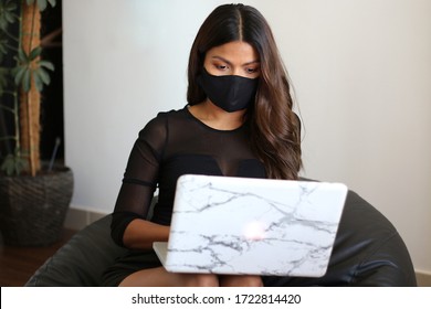 Asian Women Working From Home Wearing Black Fabric DIY  Face Mask. Protect From Covid 19, Bean Bag,white Laptop