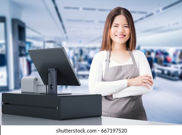 Asian Worker With Cashier Desk In Store