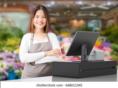 Asian Worker With Cashier Desk In Store