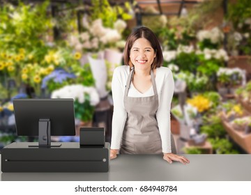 Asian Worker With Cashier Desk In Store