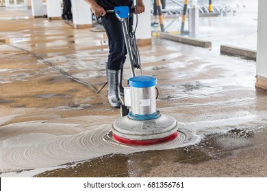 Asian worker cleaning sand wash exterior walkway using polishing machine and chemical or acid