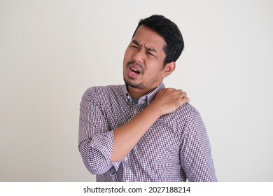 Asian Worker Man Showing In Pain Gesture On His Back Shoulder