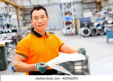 Asian Worker In Production Plant On The Factory Floor