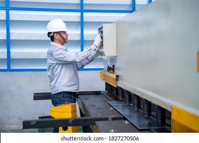 Asian Worker Wearing A Safety Suit And Setting Hydraulic Press Break Machine And Prepared Sheet Metal Shearing In Industrial Factory, Safety First Concept.