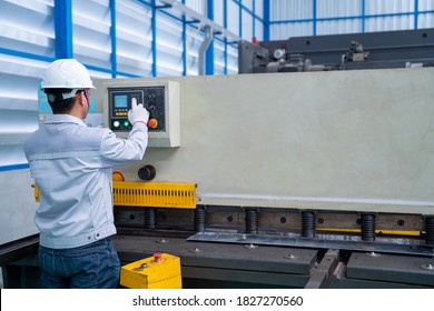 Asian Worker Wearing A Safety Suit And Setting Hydraulic Press Break Machine And Prepared Sheet Metal Shearing In Industrial Factory, Safety First Concept.