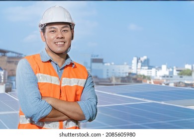 Asian Workers Engineering Standing With Confident At Rooftop Of Solar Cell Panel In Background. Operation On Site Renewable Energy Construction.