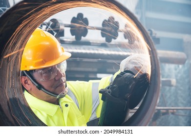 Asian workers in safety uniforms polishing castings in industrial companies, - Powered by Shutterstock