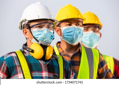 Asian workers wear protective face masks for safety in Construction site. New normal