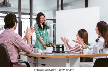 Asian Working Woman Wearing Casual Business, Presenting Her Job Plan In The Meeting And Colleagues Clapping Their Hand To Congrat On Her Success