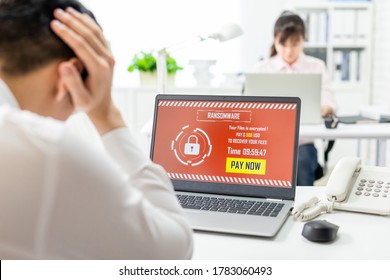 asian worried young businessman looking at laptop computer with ransomware attack words on the screen in office - Powered by Shutterstock