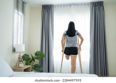 Asian young amputee leg woman wake up and stretching body in morning. Attractive female having no leg feel happy and relax, getting up from sleep on bed in bedroom at home. Leisure lifestyles in house - Powered by Shutterstock