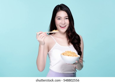 Asian Young Beautiful Woman Eat Breakfast Cereal, Beauty Face Natural Makeup, Isolated Over Blue Background.