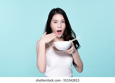 Asian Young Beautiful Woman Eating Hot And Spicy Instant Noodle,  Beauty Face Natural Makeup, Isolated Over Blue Background.