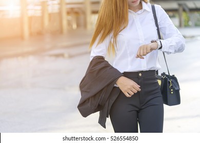 Asian Young Beautiful Woman Holding A Formal Suit, Waiting Her Friend And Looking At Her Wrist Watch. 