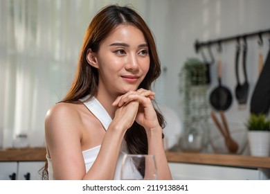 Asian Young Beautiful Woman Sitting On Dinner Table In Kitchen At Home. Attractive Girl Feel Happy And Smile While Having Night Party With Boyfriend, Enjoy Celebrate Wedding Anniversary Day In House.