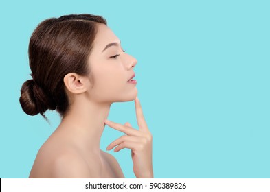 Asian young beautiful woman smiling and touching on her face, natural makeup, beauty face, isolated over blue background.