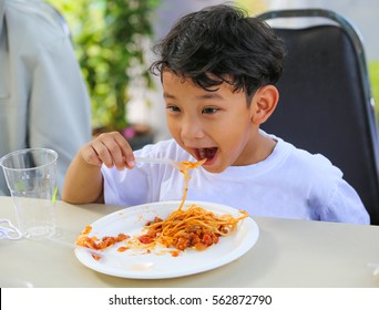 Asian Young Boy Eating Tomato Sauce Spaghetti For His Lunch. Feeling Enjoy, Delicious And Happy.