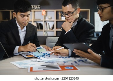 Asian Young Business People Discussing On Performance Revenue In Meeting. Businessman Working With Co-worker Team. Financial Adviser Analysing Data With Investor.