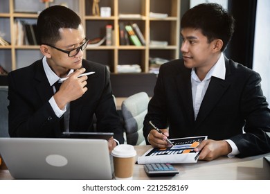 Asian Young Business People Discussing On Performance Revenue In Meeting. Businessman Working With Co-worker Team. Financial Adviser Analysing Data With Investor.