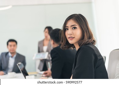 asian young business woman with braces at meeting - Shutterstock ID 590992577