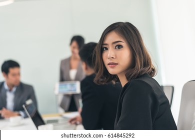asian young business woman with braces at meeting - Shutterstock ID 614845292